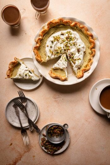 cream pie with forks, plates and coffee cups.