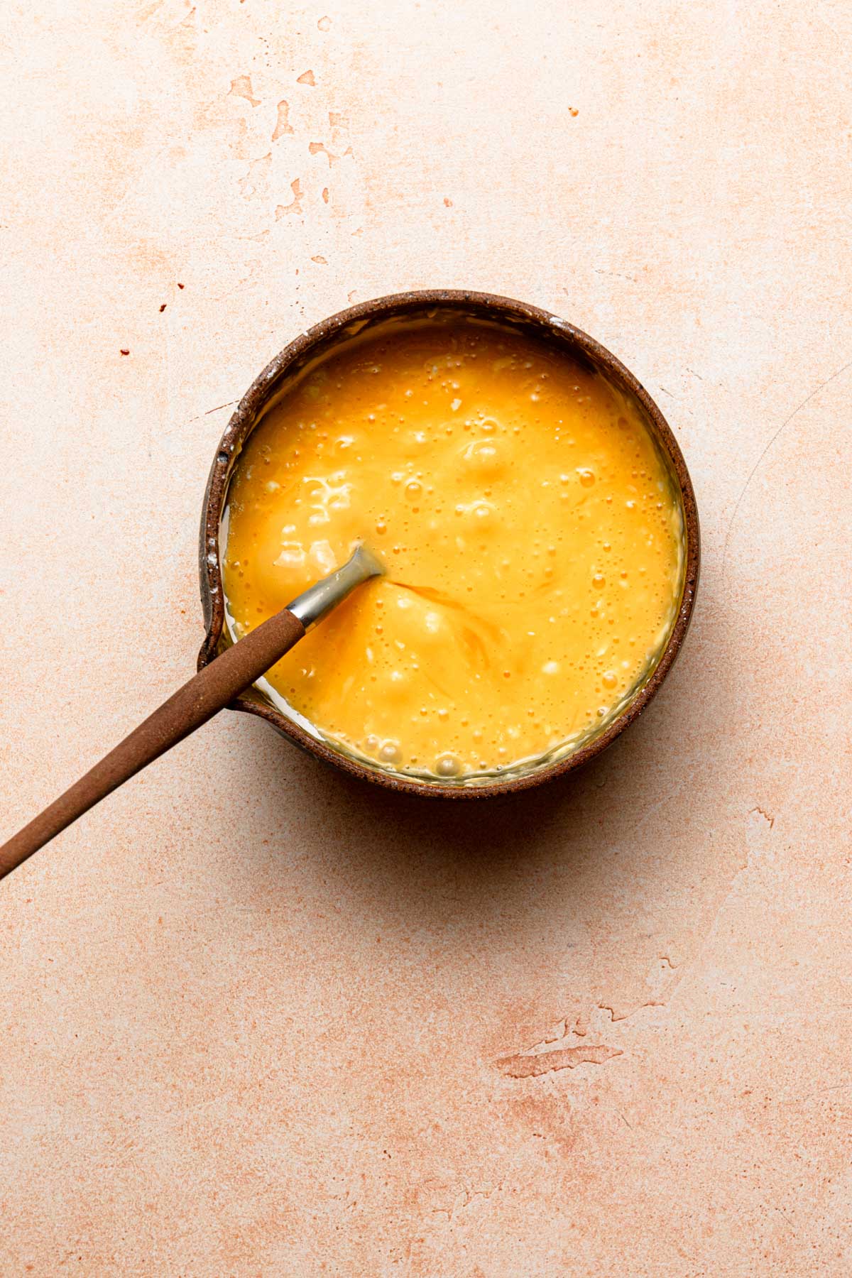 Eggs in a bowl with a fork.