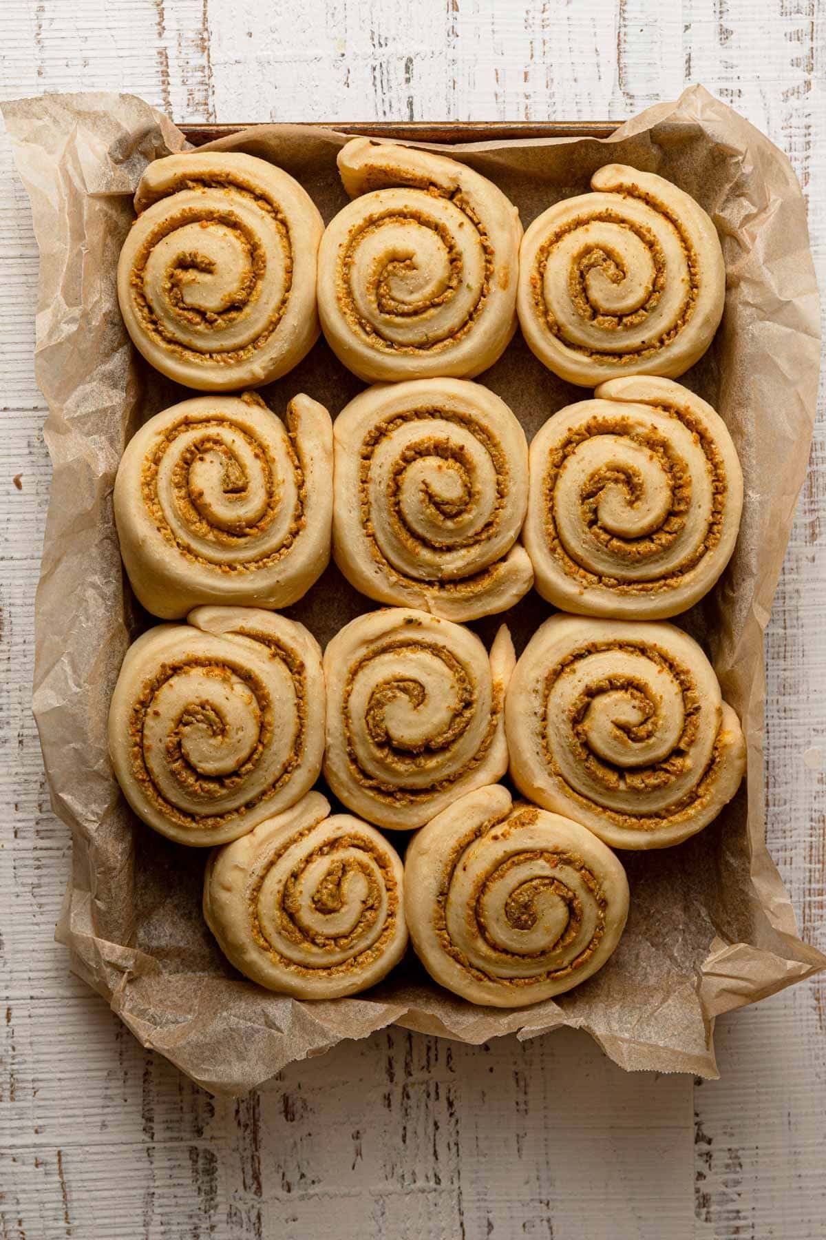 Puffed unbaked swirled pistachio pastries.