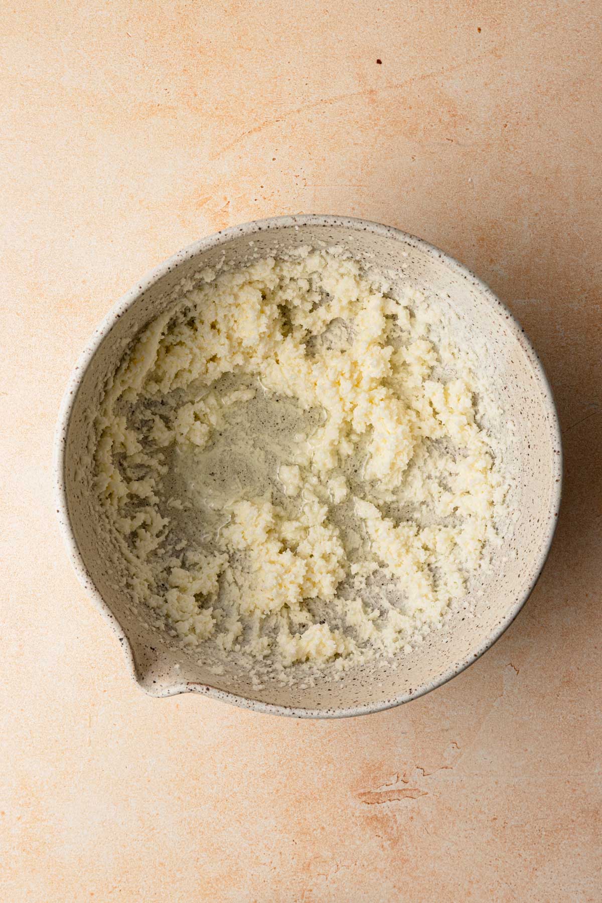 A large bowl with cream butter and sugar.