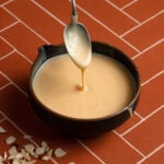 A bowl with glaze, and a spoon.