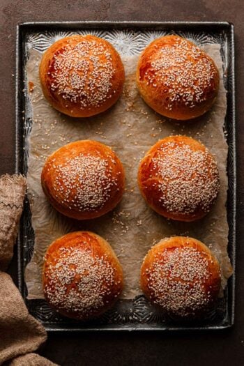Burger buns topped with sesame seeds.
