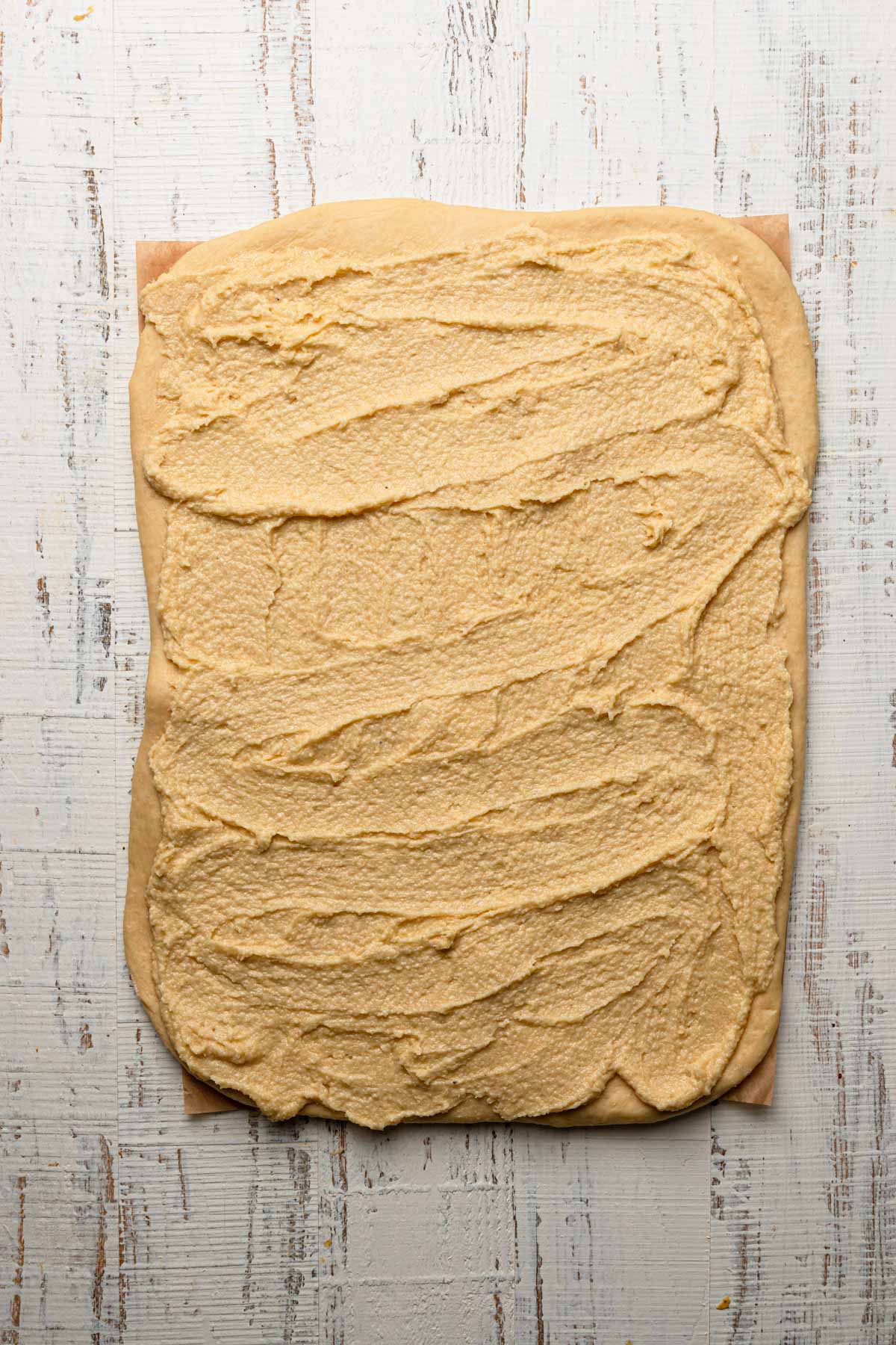A dough rolled into a rectangle topped with almond cream.