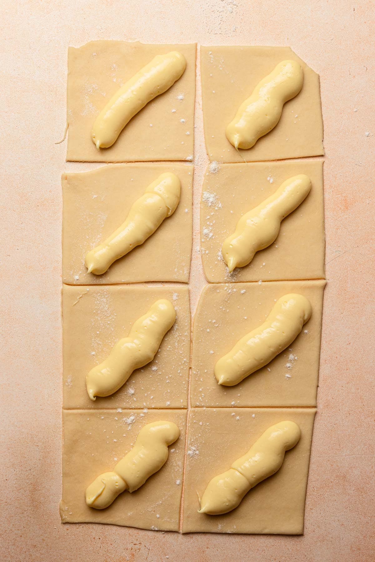 Dough rectangle cut into 8 squares, topped with cheese cream.