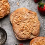 double baked brioche slice topped with almond cream and sliced almonds.