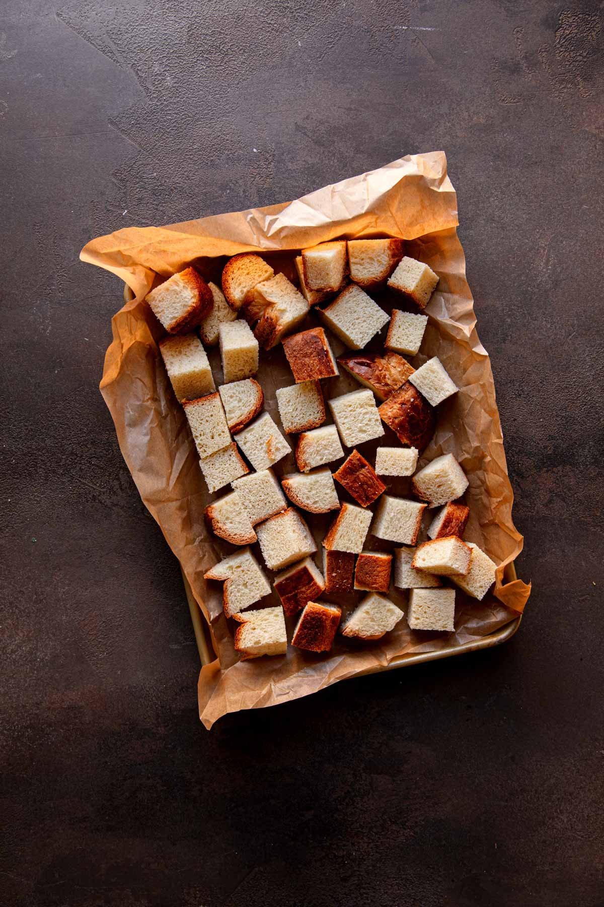 Cube bread in a baking dish.