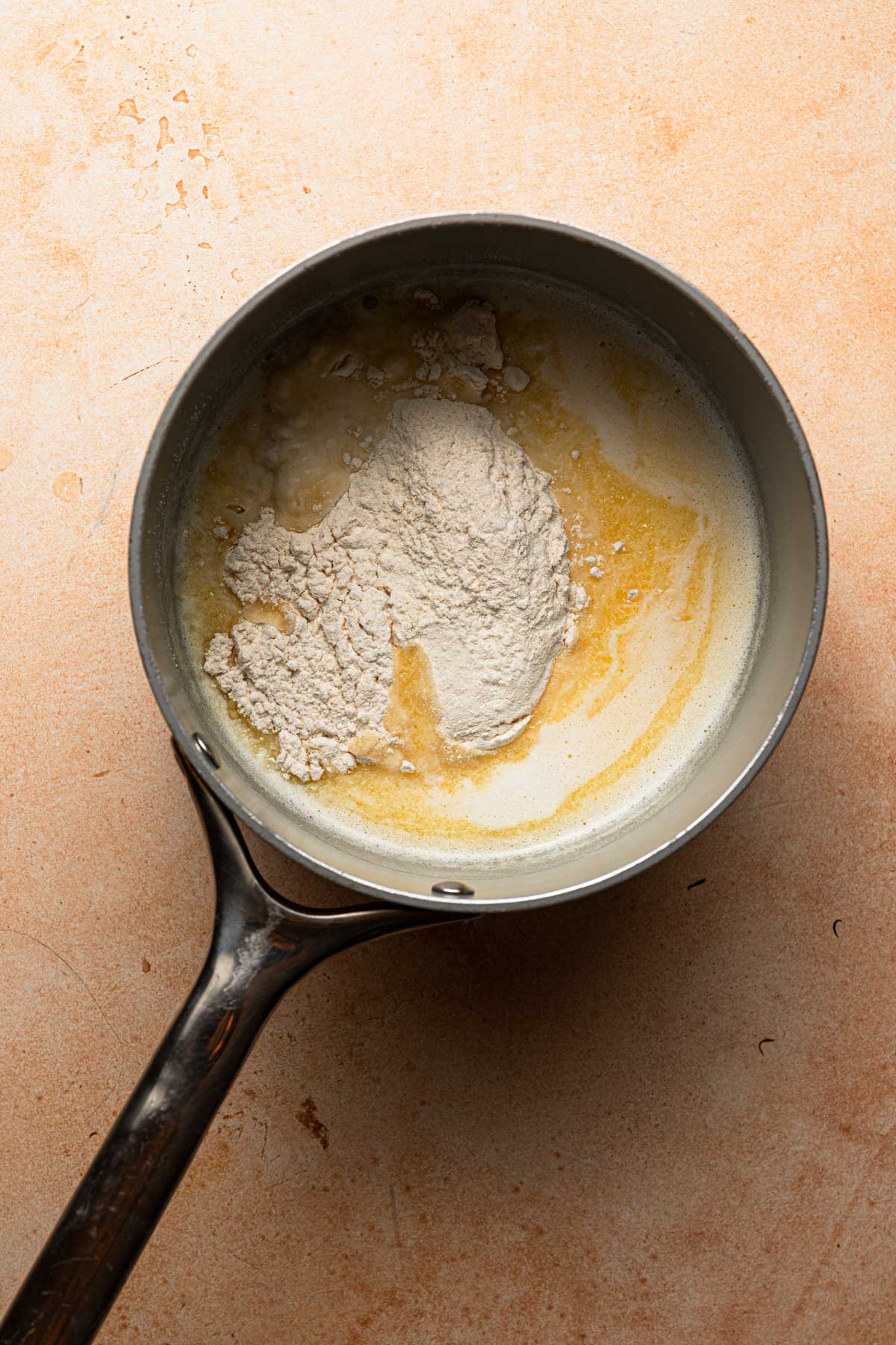 A saucepan with milk, melted butter and flour.