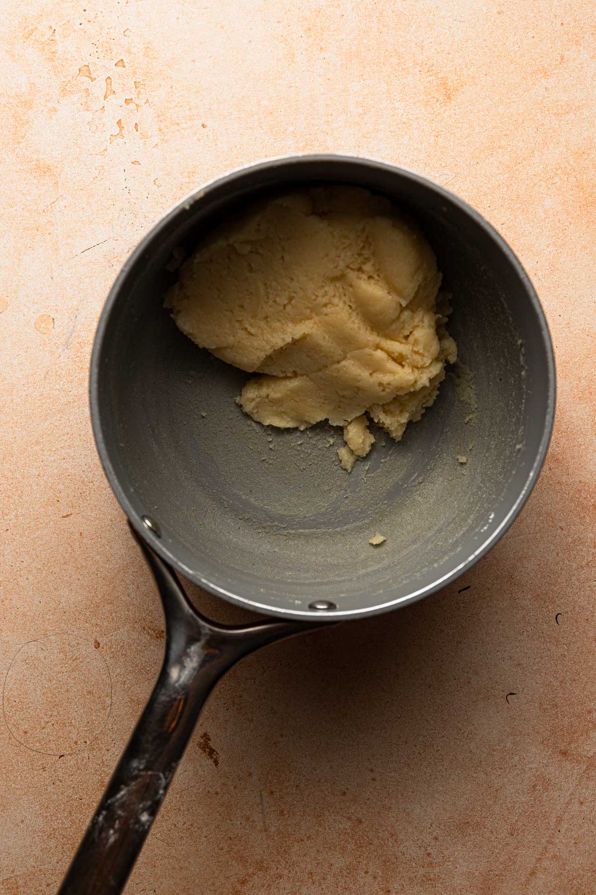  A saucepan with choux pate dough.