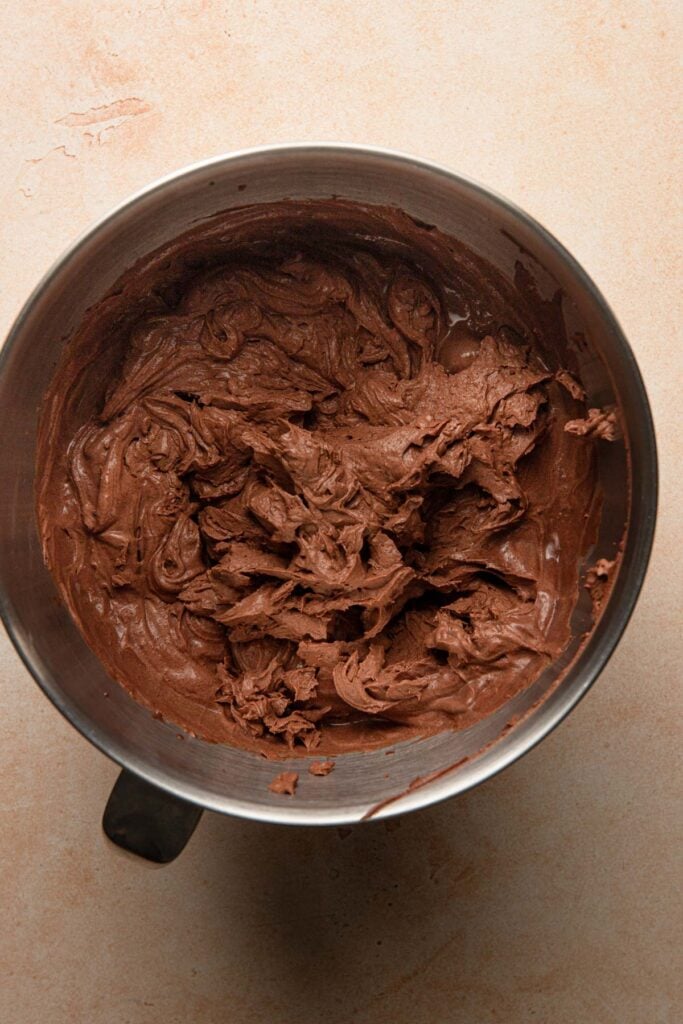 A mixer bowl with whipped chocolate ganache.