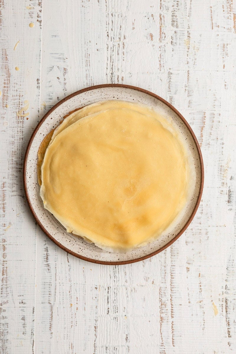 A plate topped with blintzes wrappers.