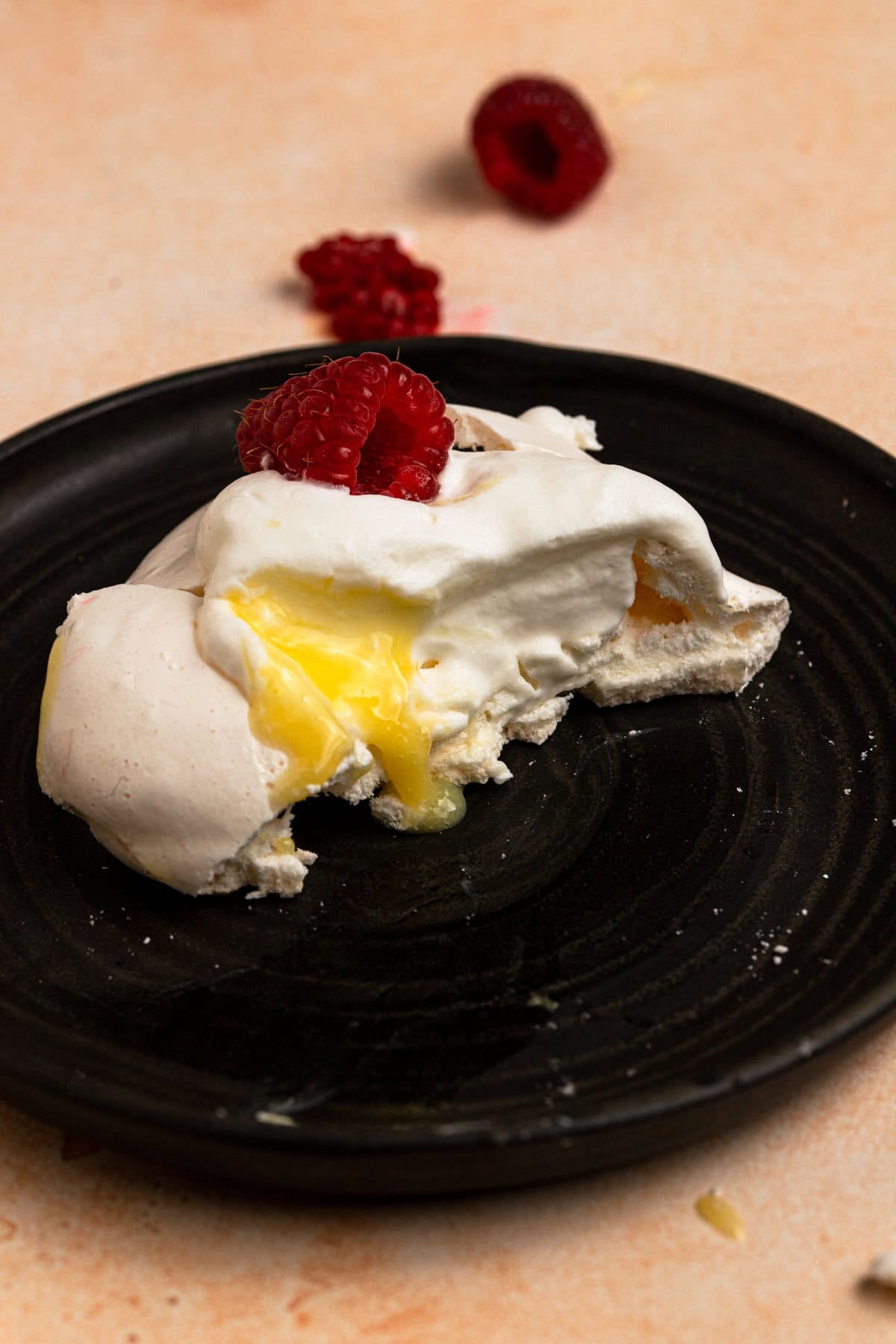 pavlova topped with fresh raspberry.
