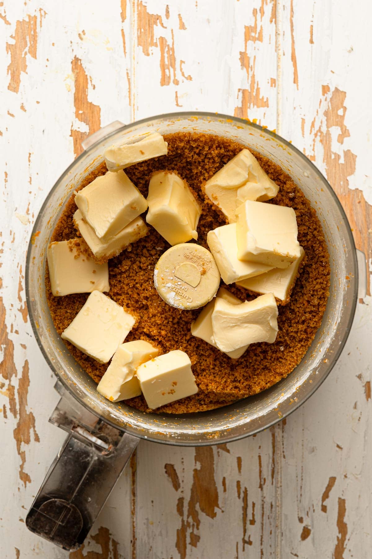 A food processor bowl with sugar and butter.