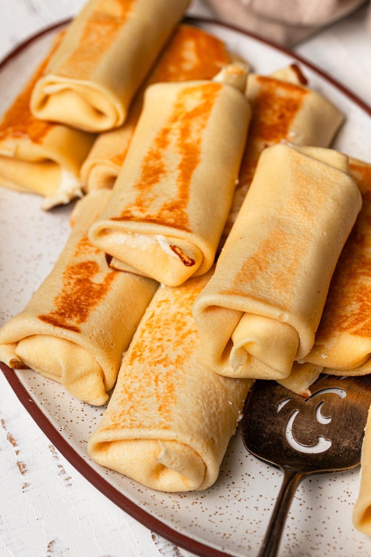 A plate topped with blintzes.