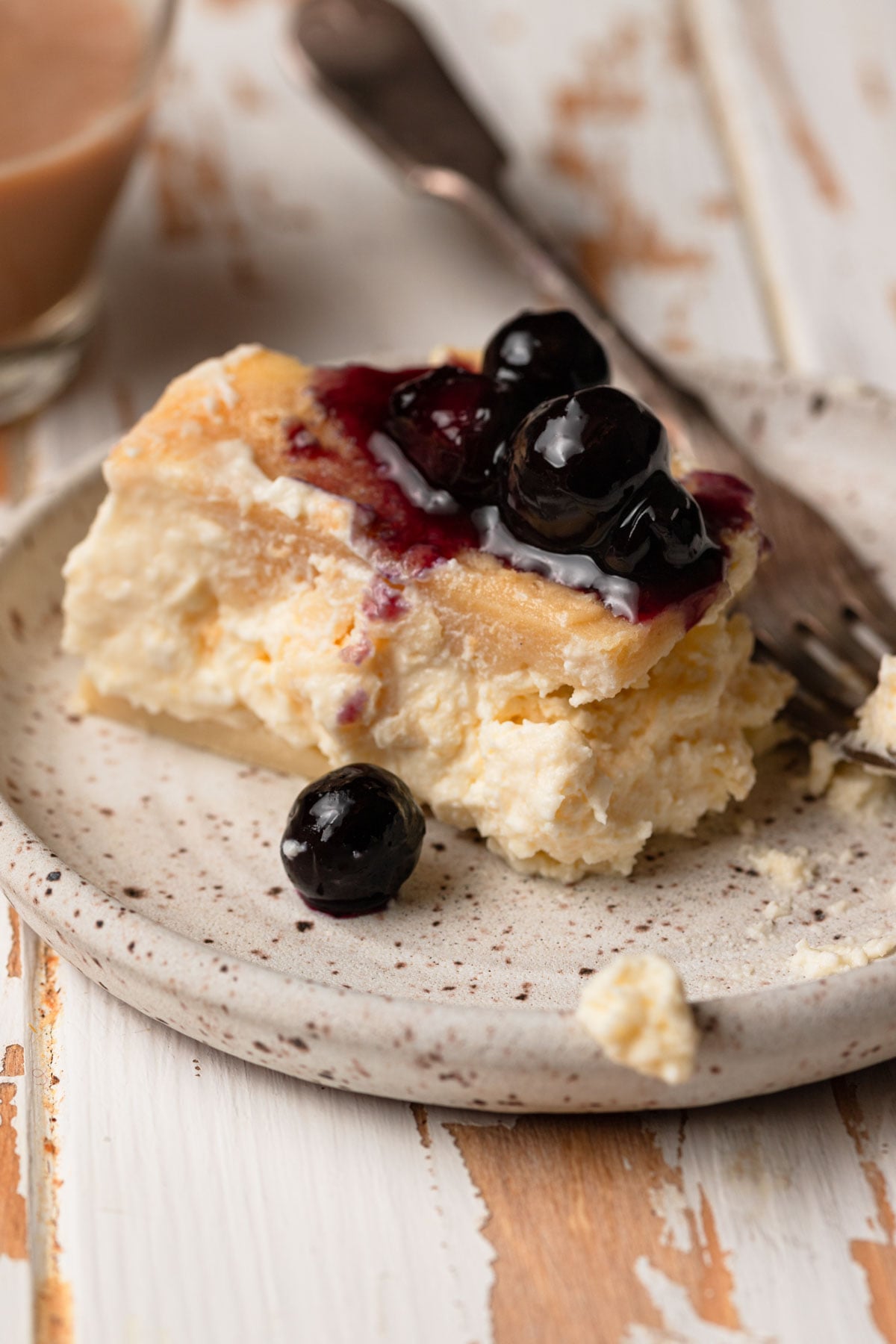 Cheesy crepe casserole topped with blueberries.