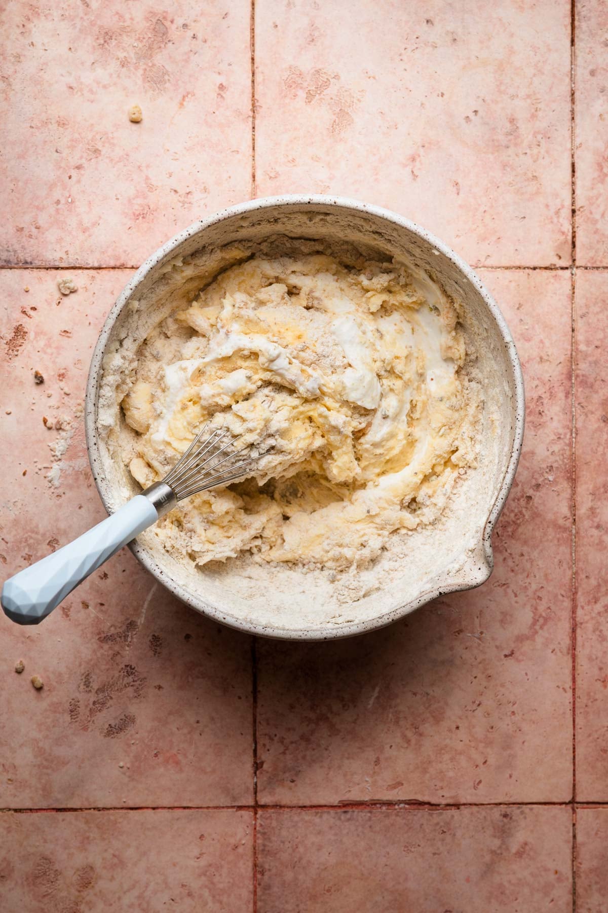 A large bowl with thick batter and a whisk.
