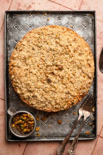 Pistachio coffee cake on a tray with forks.