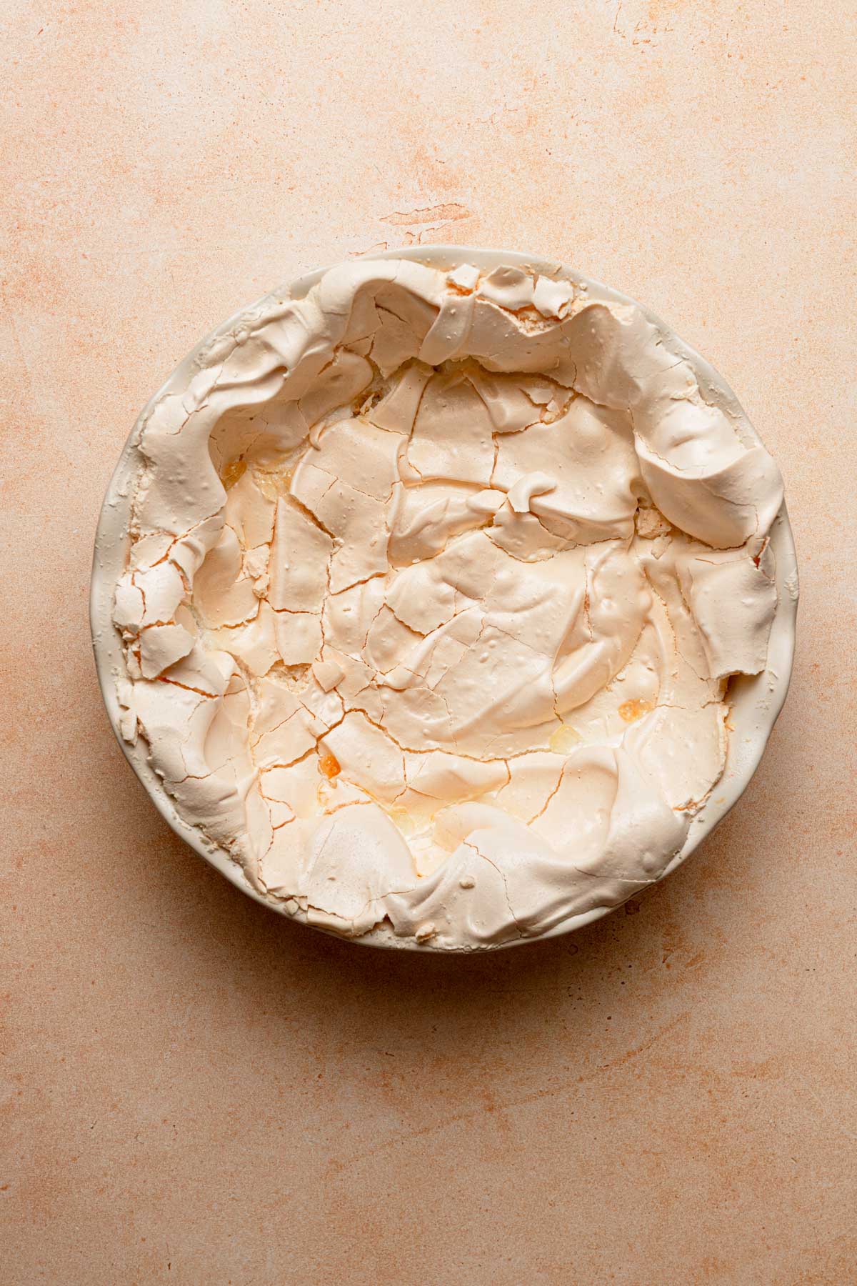 A baked meringue crust in a pie dish.