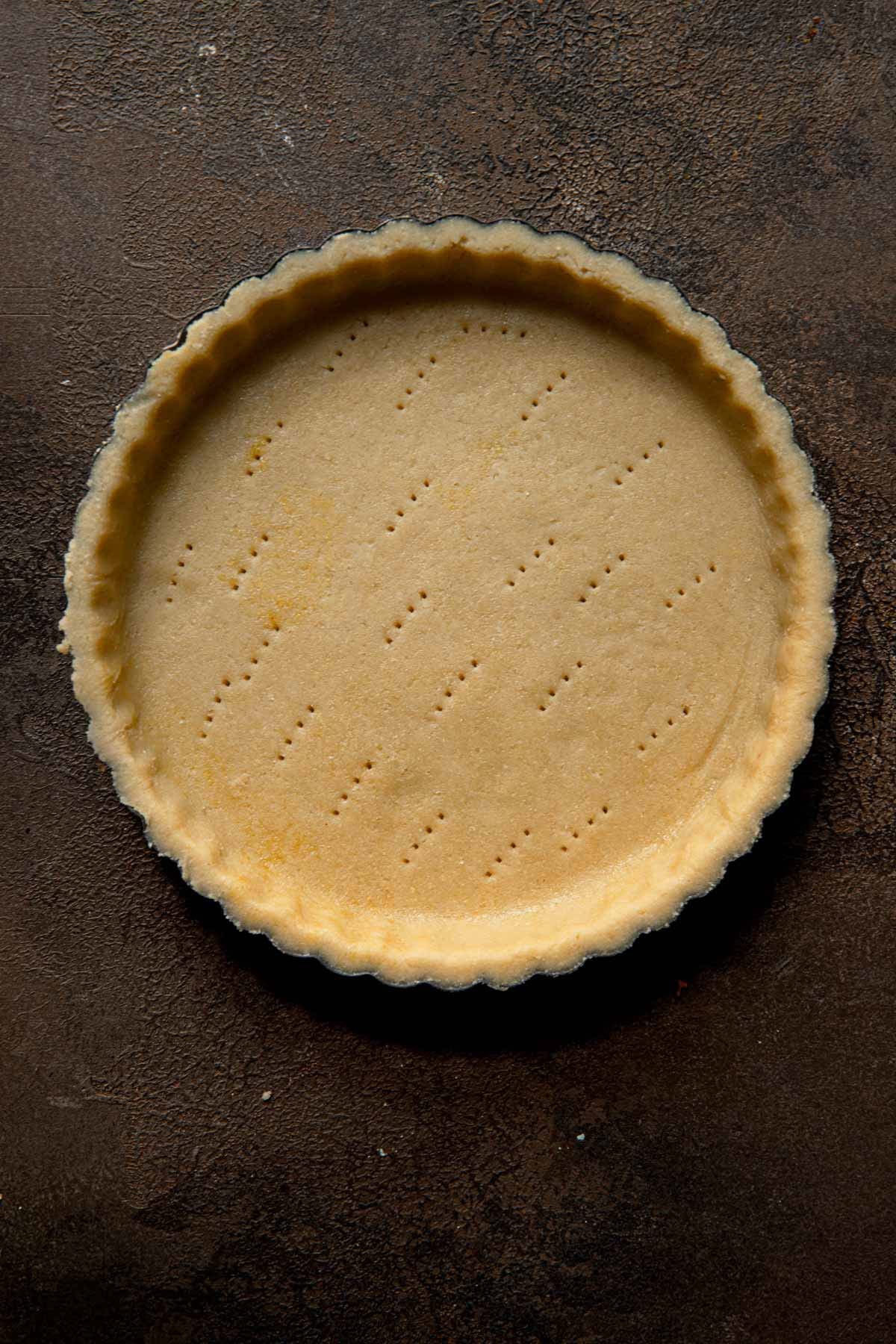 Unbaked short crust dough in tart pan.