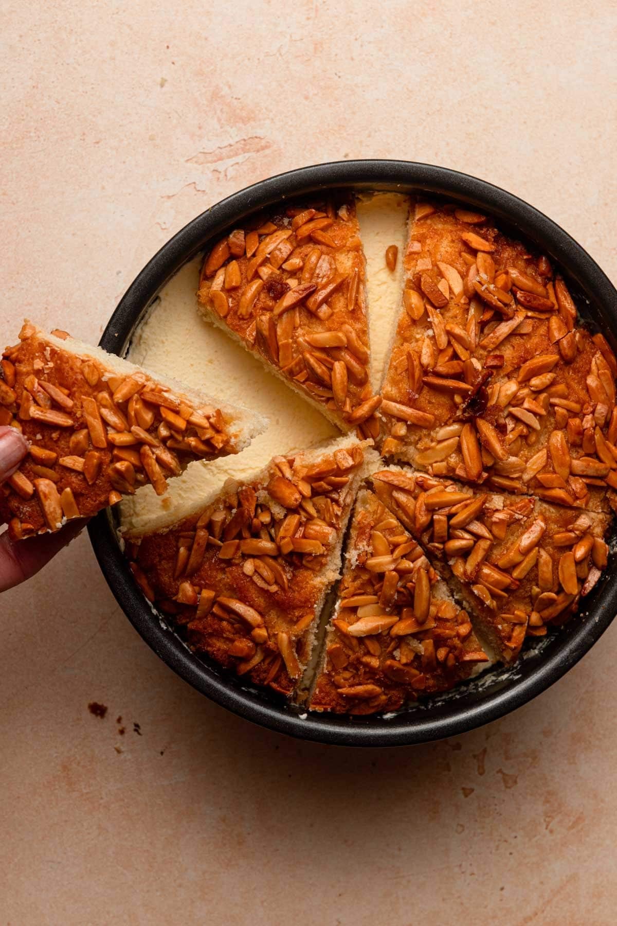 Hand topping bee sting cake with the sliced brioche topping.