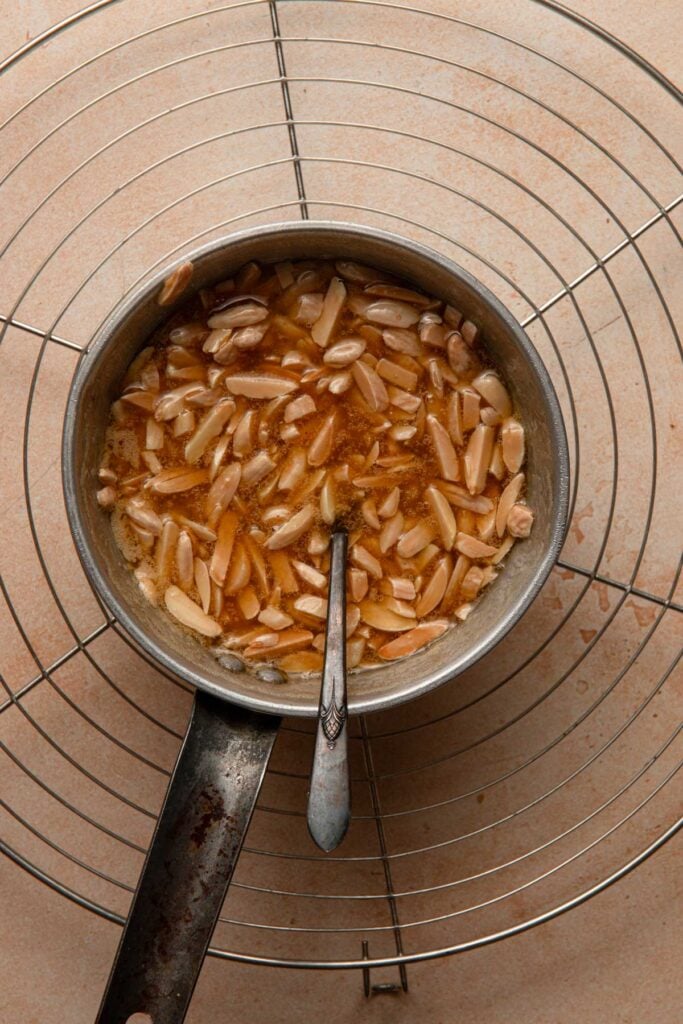 A sauce pan with honey almonds Bee sting topping.