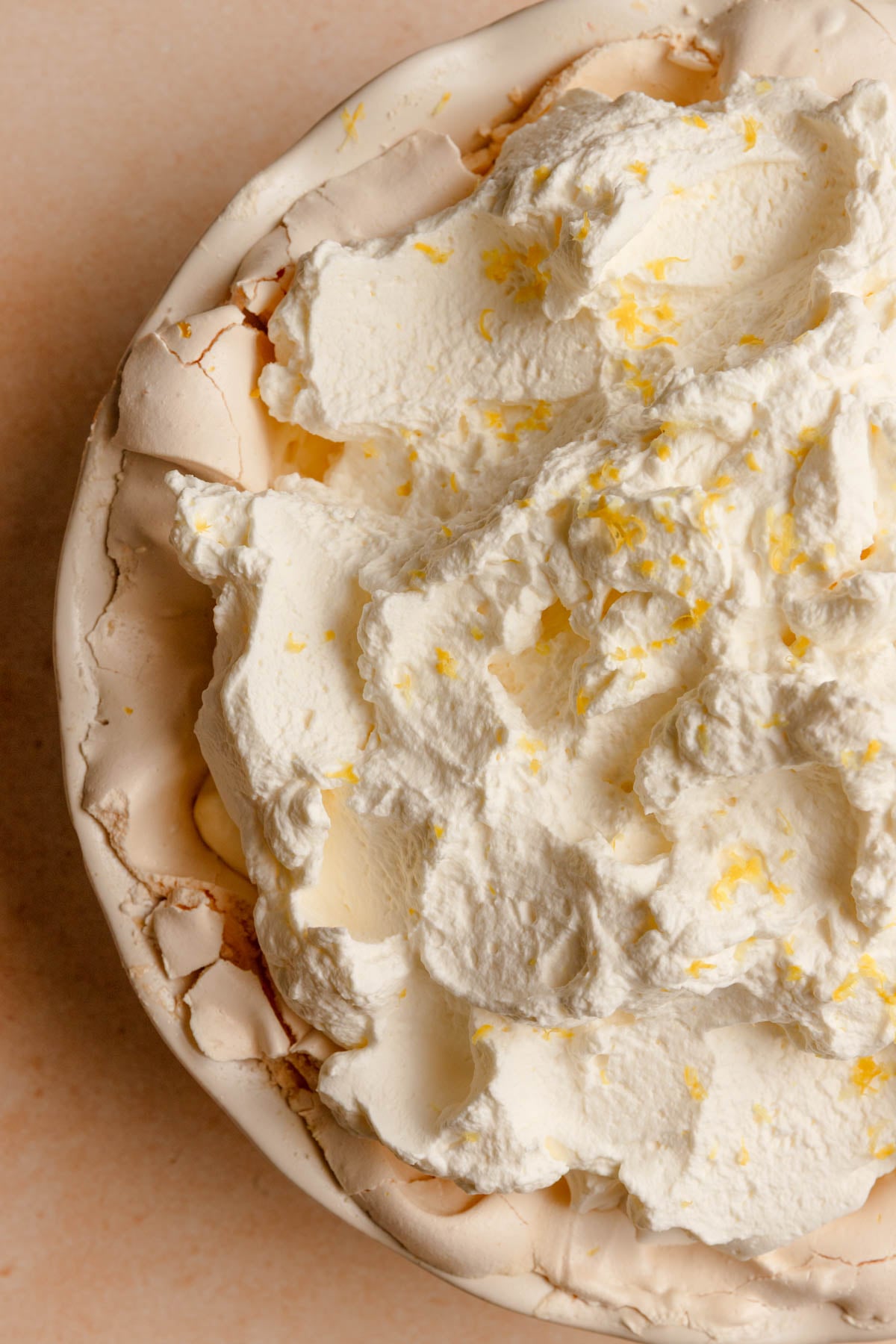 angel pie topped with cream and lemon zest.
