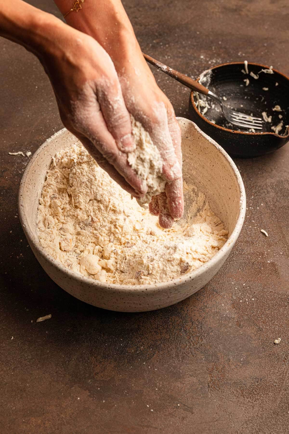 Rubbing butter into flour mixture for scone dough.