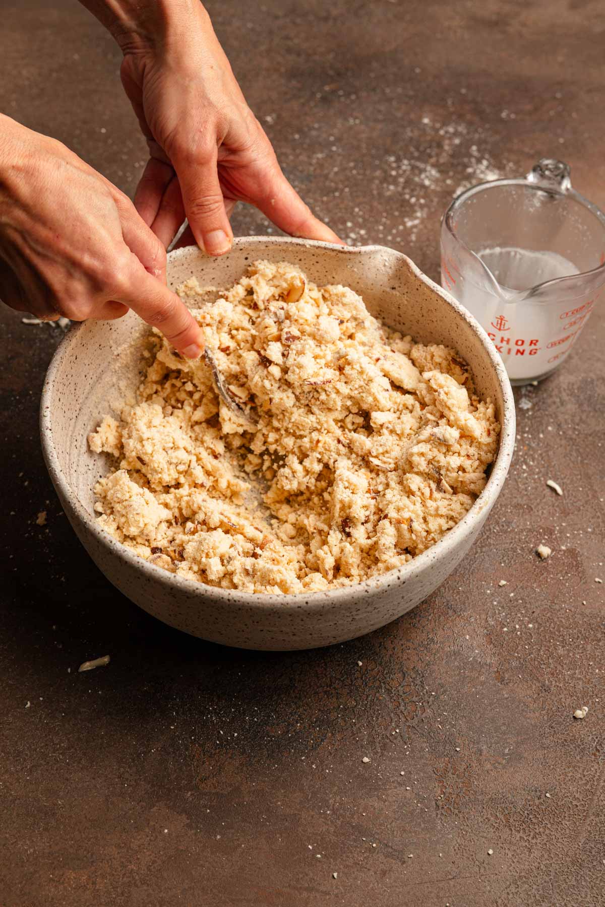 Tossing dough with a fork.