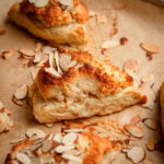 almond scone topped with almond paste and sliced almonds.