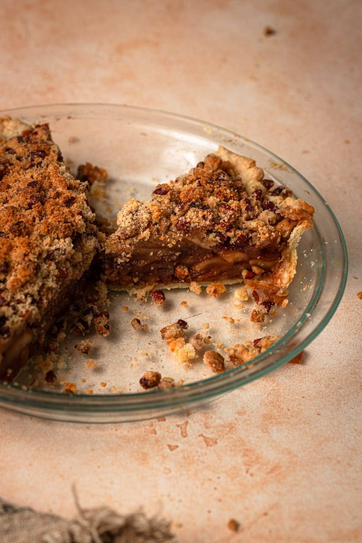 Sliced apple pie topped with crumble.