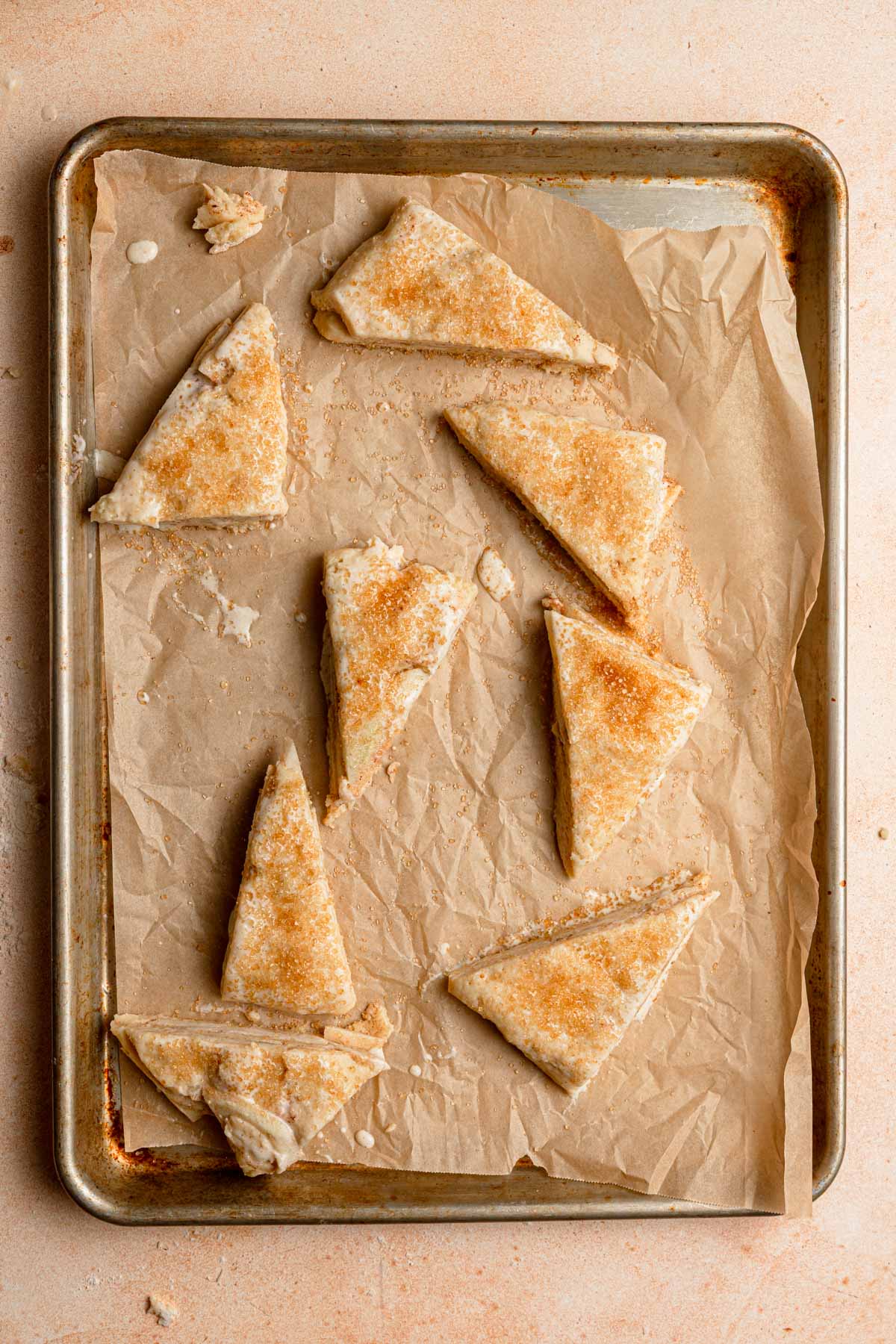 Unbaked scones topped with turbinado sugar.