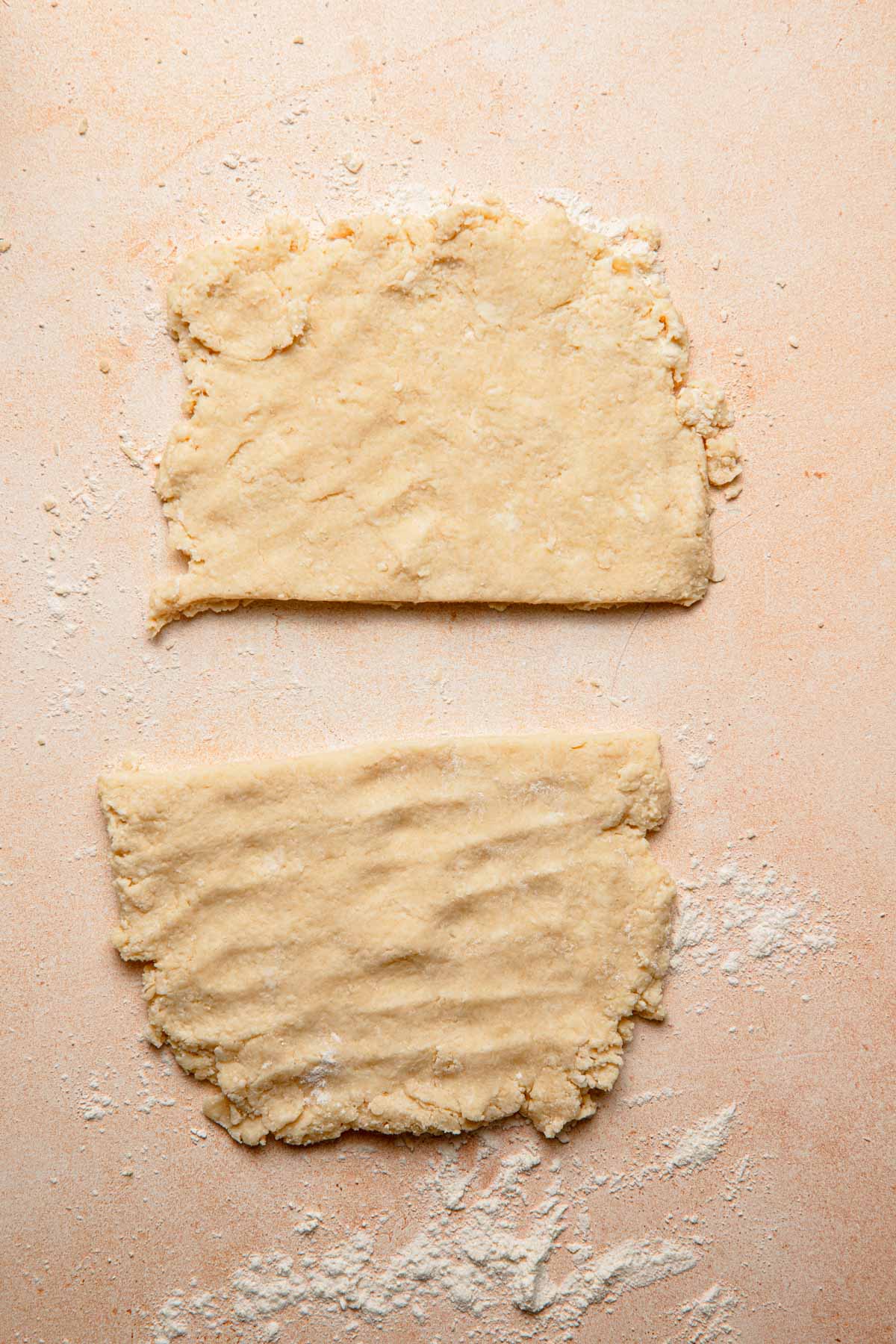 Scones dough pressed into a rectangle and cut into two parts.