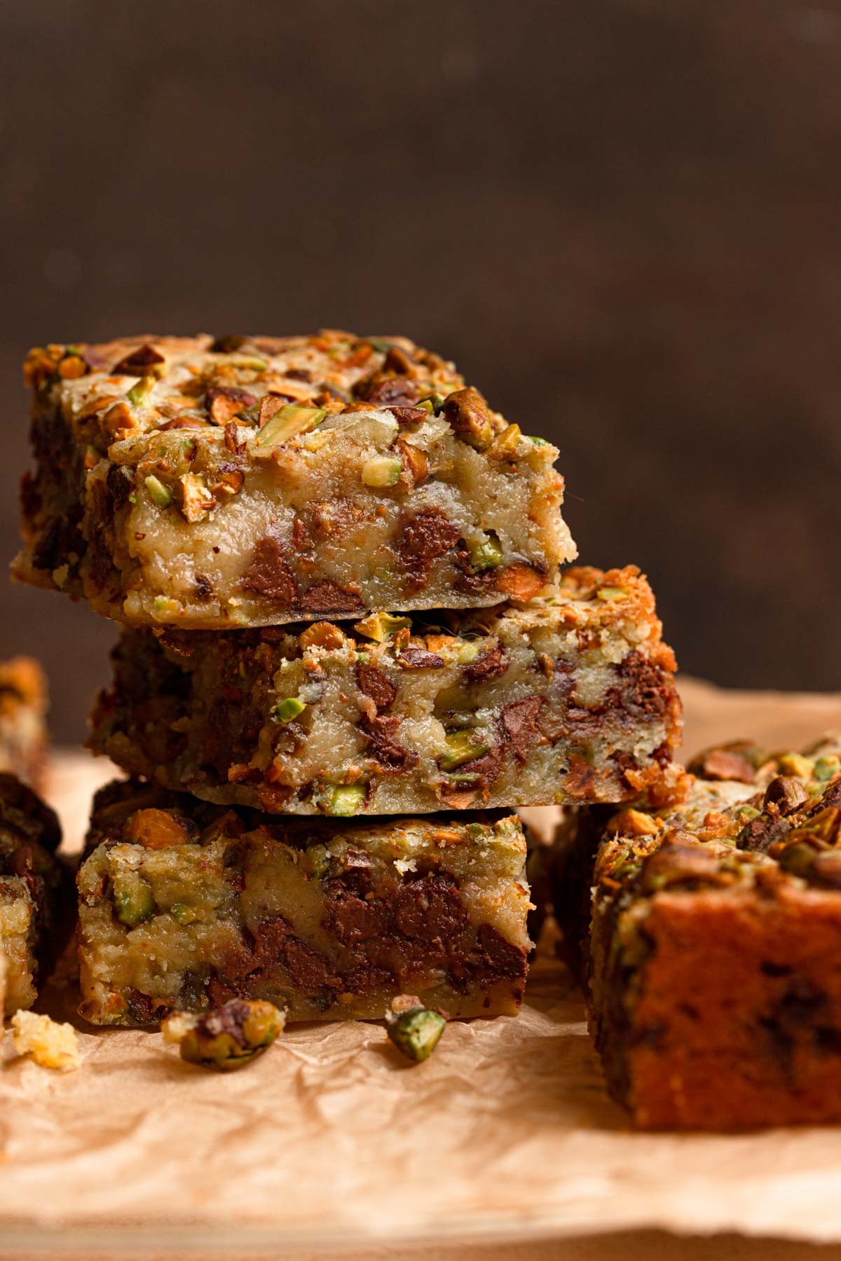 Three blondies with pistachios and chocolate chips.
