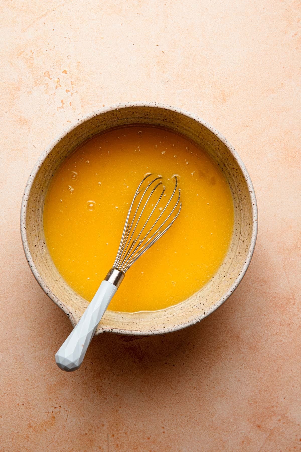 A mixing bowl with eggs and butter mixture.